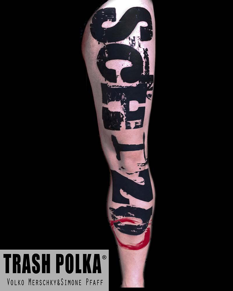 trash polka leg tattoo big massiv schizo lettering on the front side