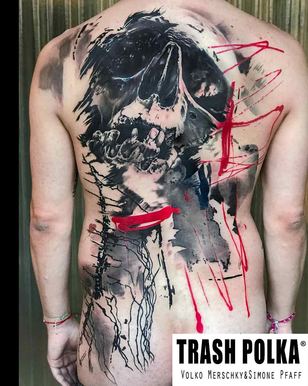 trash polka tattoo on a back red ink lines a big skull and graphic art