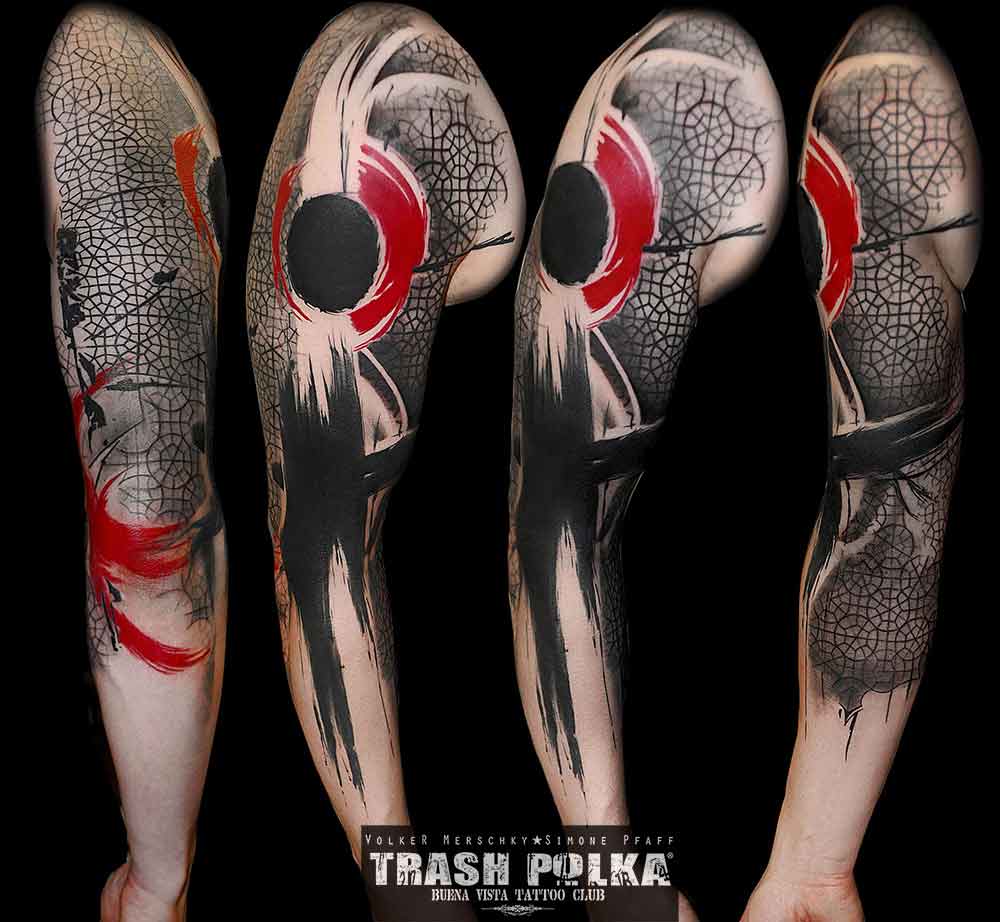 trash polka tattoo arm bold brush art in red and black