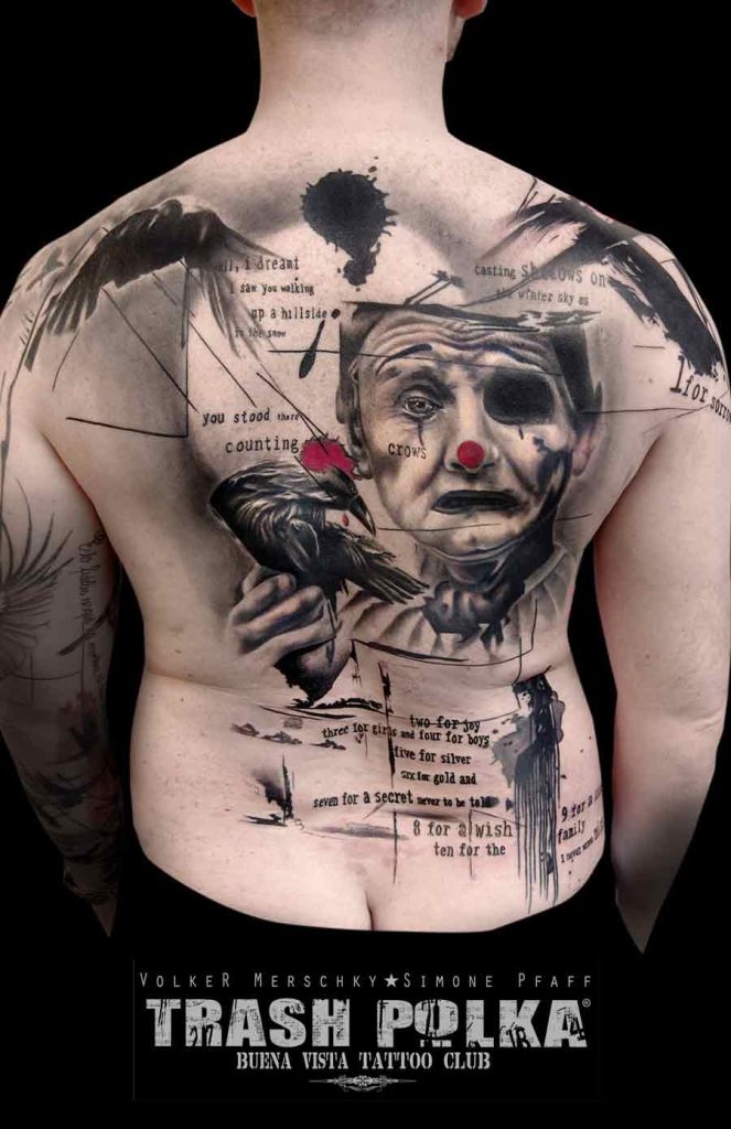 A trash polka tattoo on a man's back a sad clown with a raven on his hand