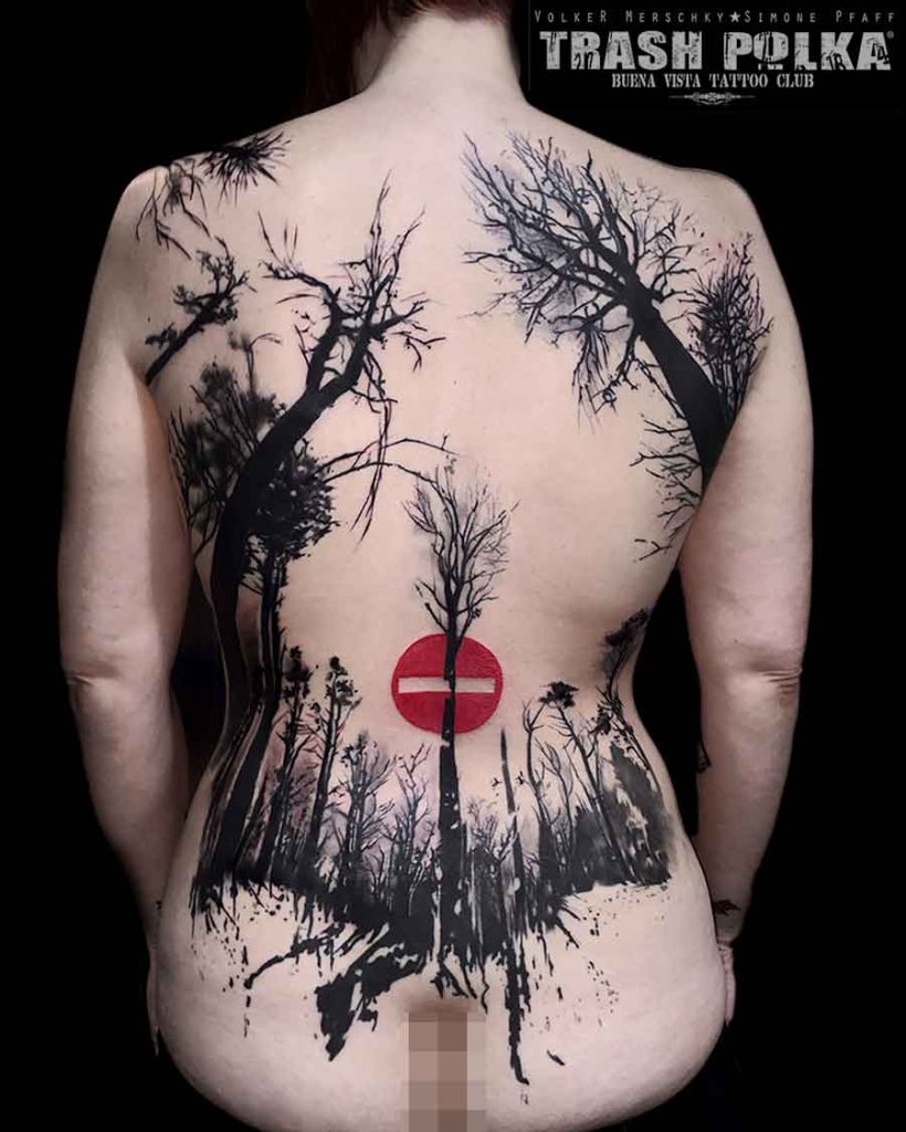 trash polka tattoo on a girl the back i framed with trees in the forest is a red no trespass sign