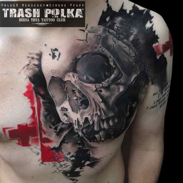 trash polka tattoo a shading skull on a chest with black and red crosses