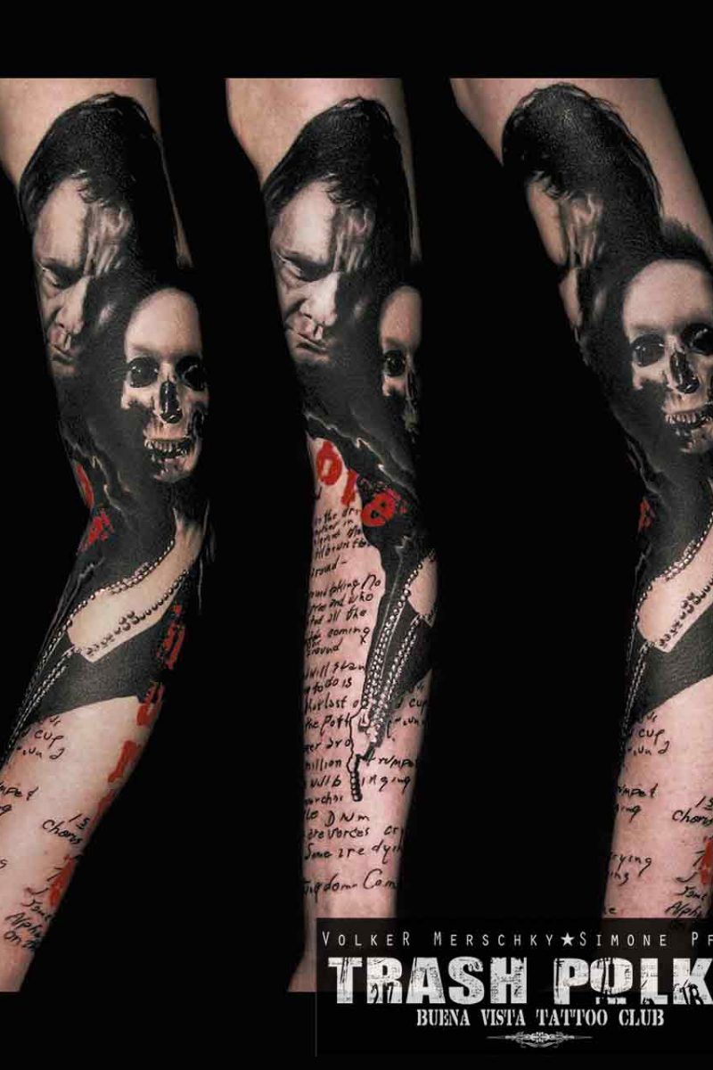 trash polka tattoo on the upper arm shows johnny cash and in his arm a skeleton meant to represent june carter cash